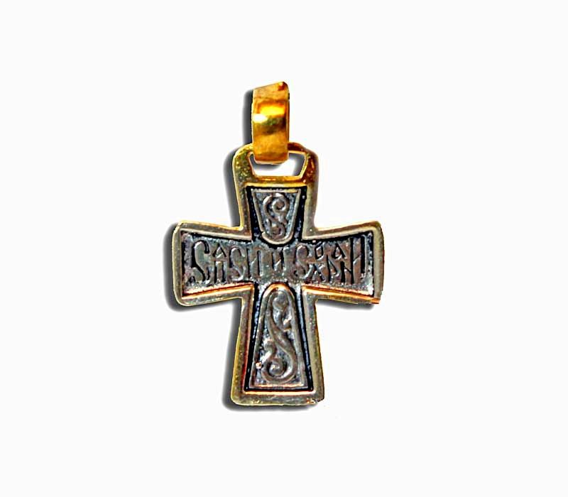 A silver and gold cross pendant with intricate detailing, made in Jerusalem.