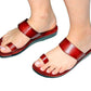 Red sandals worn on feet against a white background