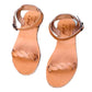 Pair of tan sandals on a concrete surface
