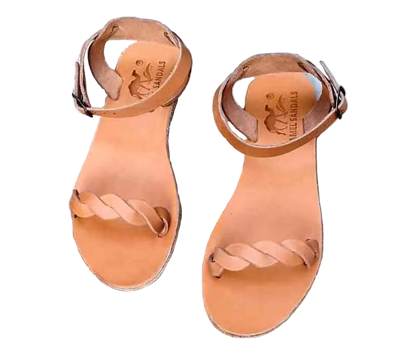 Pair of tan sandals on a concrete surface