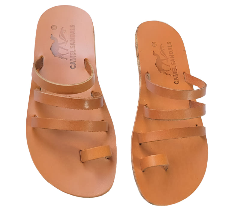 Pair of tan sandals with multiple straps on a white background
