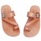 Pair of tan sandals with buckles on a white background