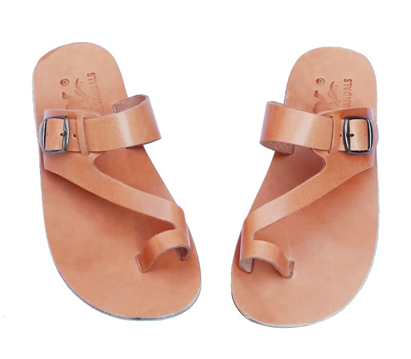 Pair of tan sandals with buckles on a white background