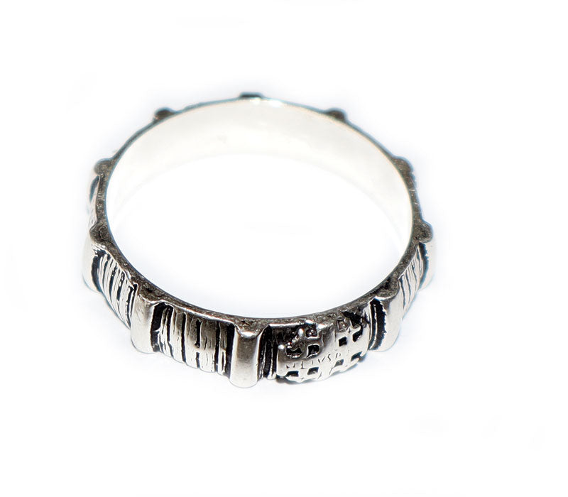 Silver ring with a white stone on a white background