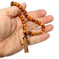 Hand holding a olivewood rosary 