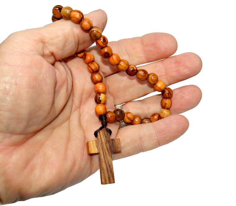 Hand holding a olivewood rosary 