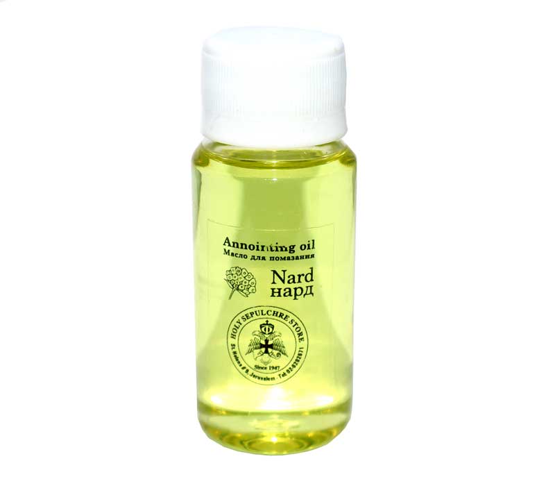 Bottle of Nard annointing oil with a white cap on a white background