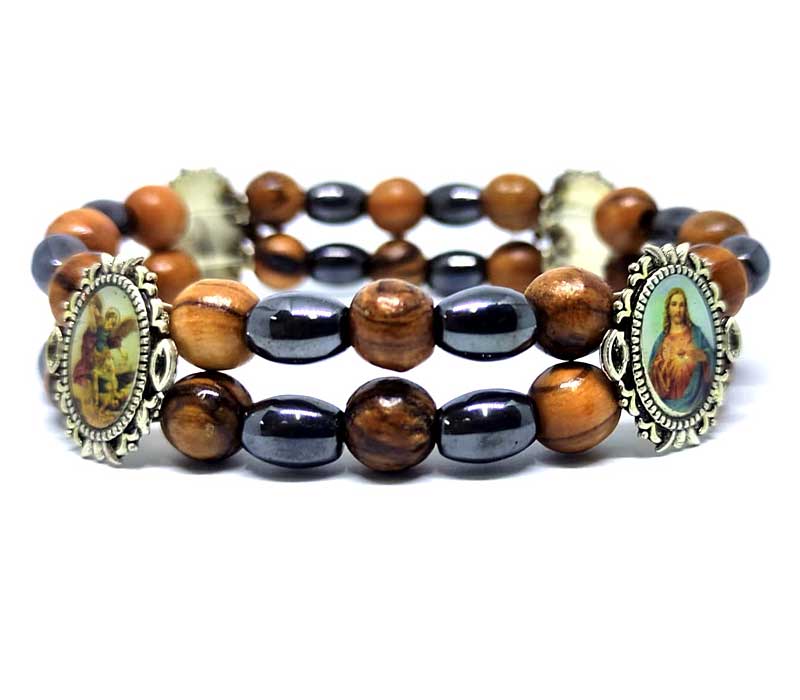 Stack of beaded bracelets with religious-themed charms on a white background