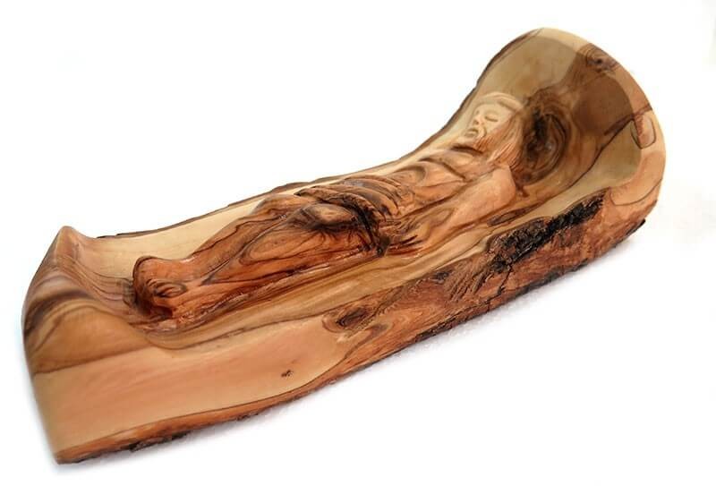 olive wood statue of Jesus lies on the Holy Anointing Stone