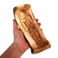 olive wood statue of Jesus lies on the Holy Anointing Stone